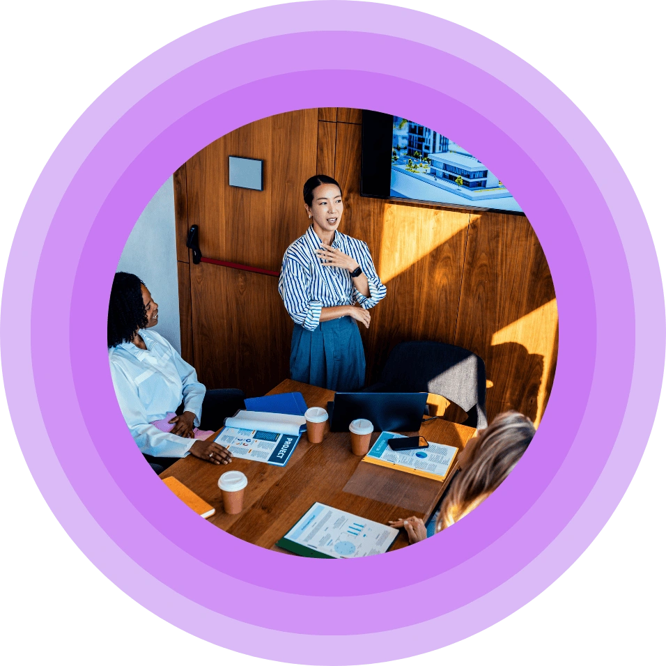 A woman speaking in front during a meeting.